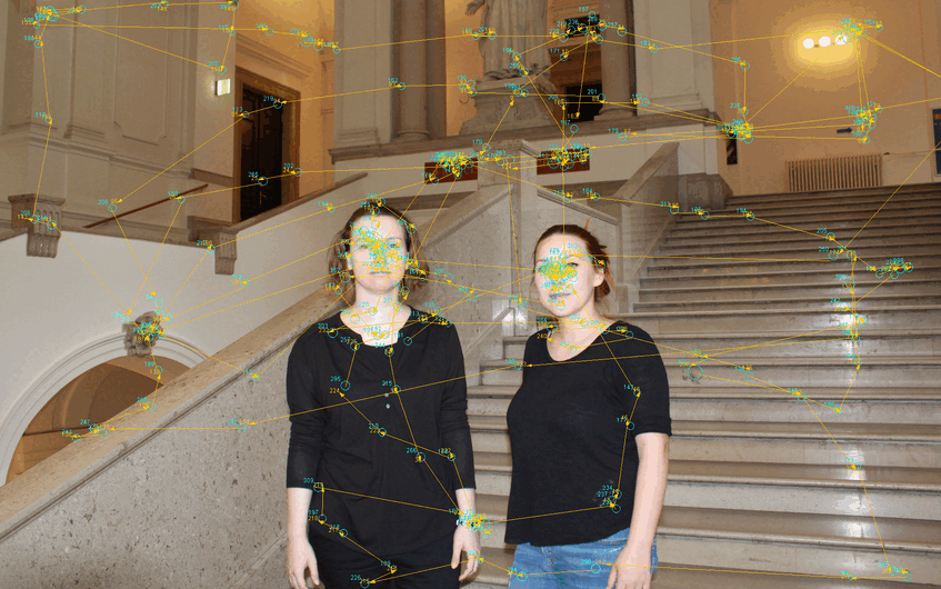 Two women standing in the main building of the University of Vienna with eye scan path from eye tracking data