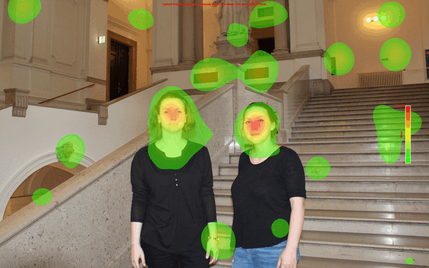Two women standing in the main building of the University of Vienna with heat map from eye tracking data